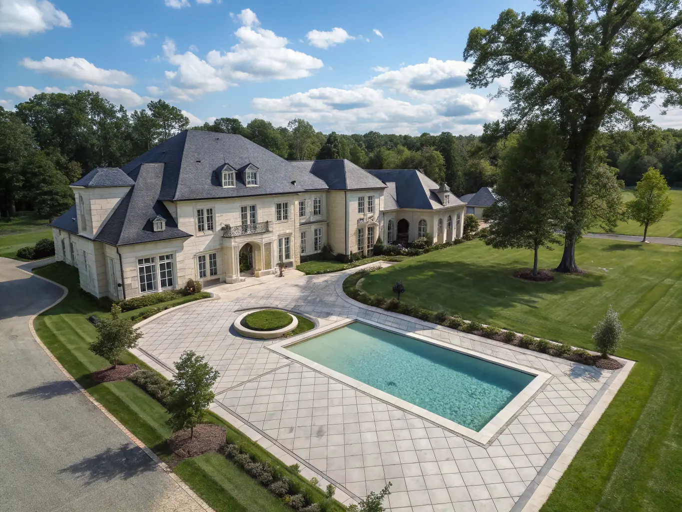 Aerial shot of a spacious estate with surrounding greenery and nearby amenities, captured by Back Porch Media's drone to provide a comprehensive perspective.